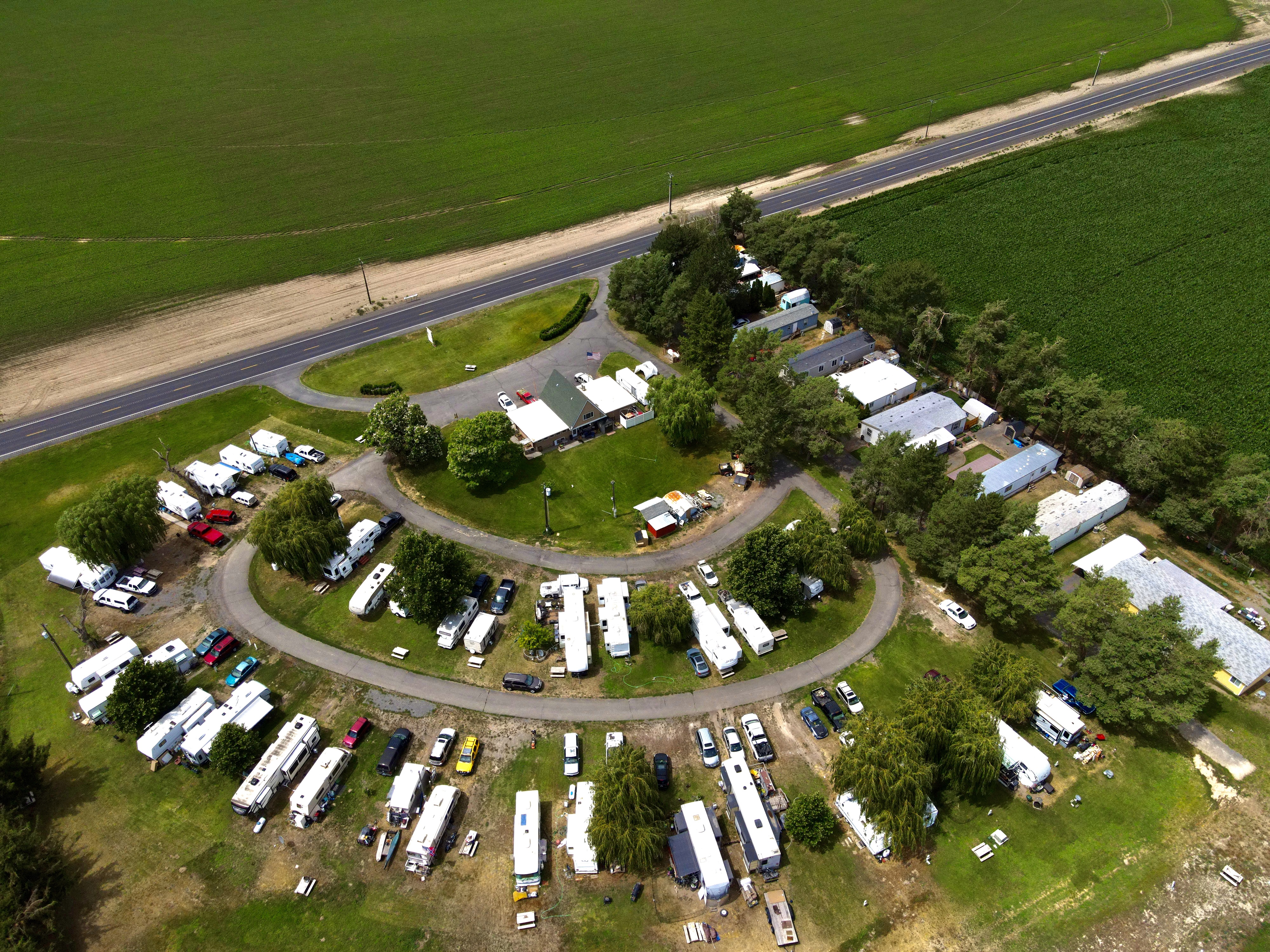 Aerial view of Willows Trailer Village in Moses Lake, WA, showing the horseshoe loop drive, RV sites, and main office surrounded by Columbia Basin farmland